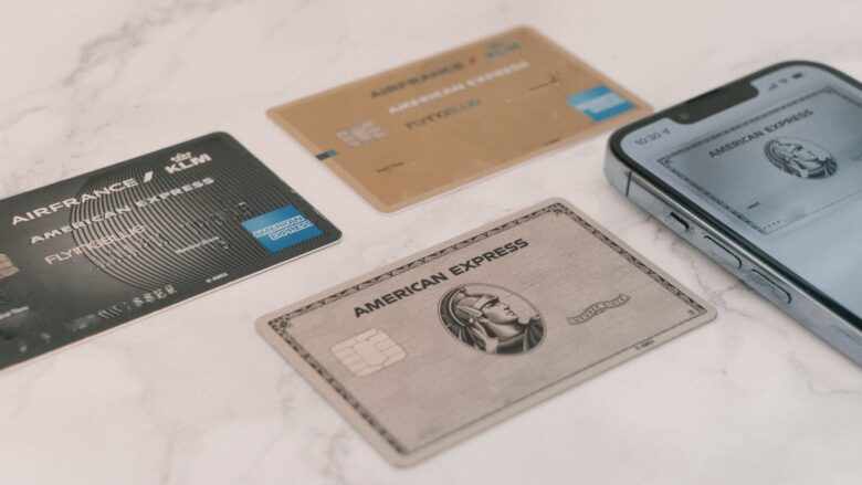 Credit cards next to a phone, representing tracking a balance transfer deadline