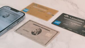 Credit cards next to a phone, representing comparing cashback rewards for everyday spending