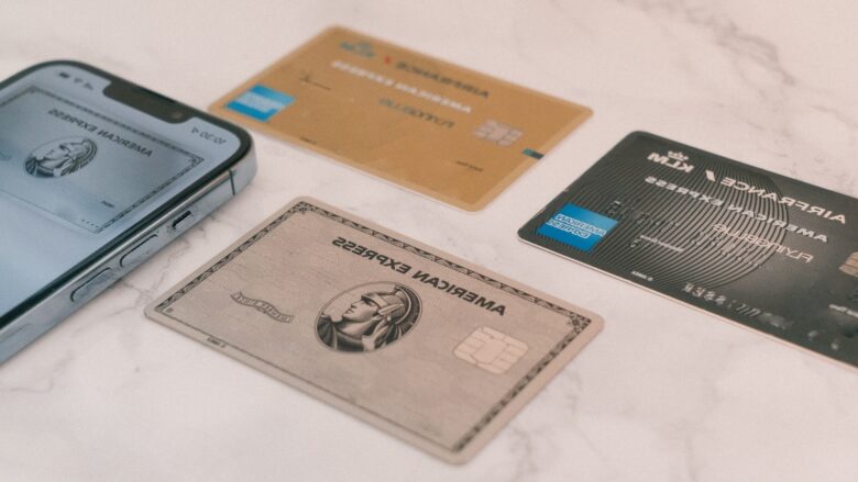 Credit cards next to a phone, representing comparing cashback rewards for everyday spending