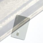 Silver credit card resting on a table, representing a first starter card for building credit