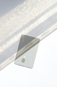 Silver credit card resting on a table, representing a first starter card for building credit