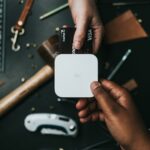 Person holding a credit card, representing common credit score myths and how credit cards affect your score