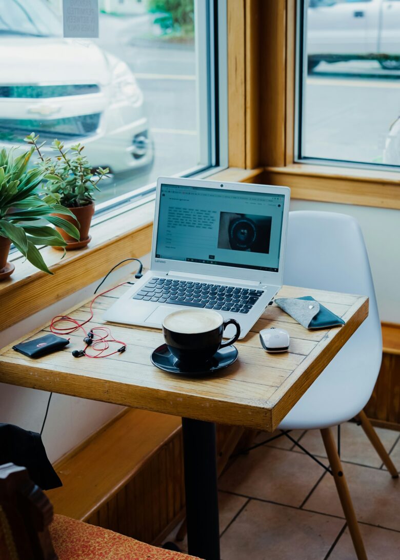 Freelancer working on a laptop with coffee, representing gig work and irregular income