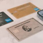 Several credit cards laid out next to a phone, representing comparing no annual fee card options