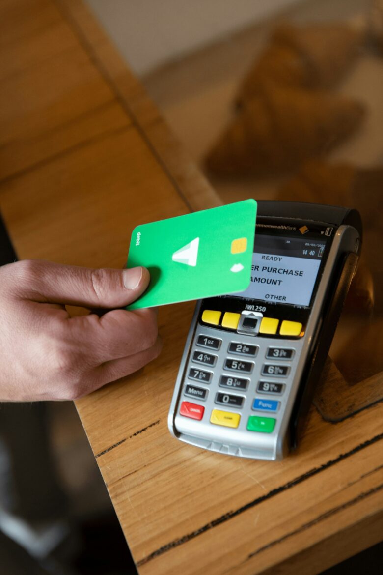 Person reviewing credit card rewards and spending with a calculator